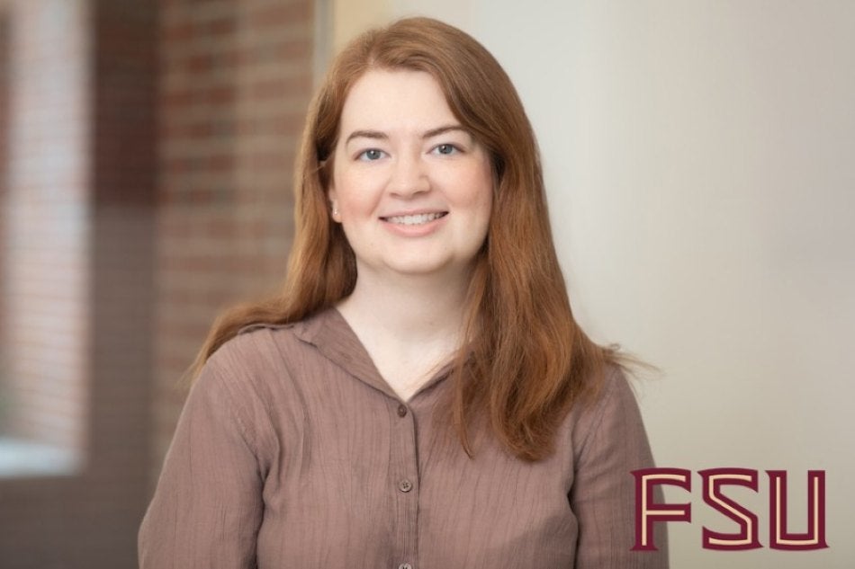 Professional headshot of Amy Webster, a smiling woman with long reddish-brown hair, wearing a mauve button-down shirt. An FSU logo is in the bottom right corner.